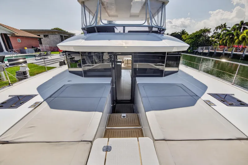 Slide: The Image of 2022 Leopard 53 Powercat yacht with spacious deck and modern design, docked by a canal. - 50