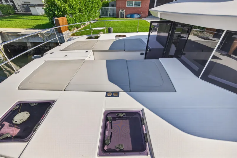 Slide: The Image of 2022 Leopard 53 Powercat yacht deck with cushioned seating and hatches. - 52