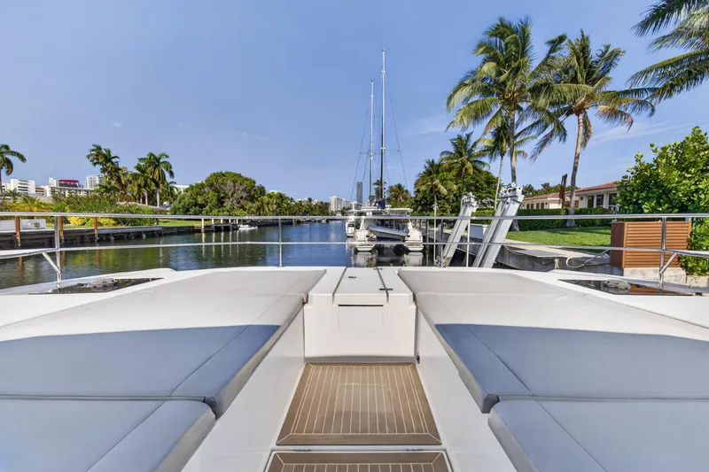 Slide: The Image of Leopard 53 Powercat 2022 yacht docked, surrounded by palm trees and calm waters. - 53