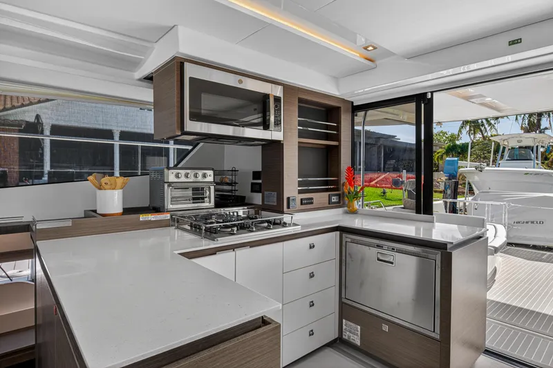 Slide: The Image of Modern kitchen interior on 2022 Leopard 53 Powercat yacht, featuring sleek appliances and spacious countertops. - 55