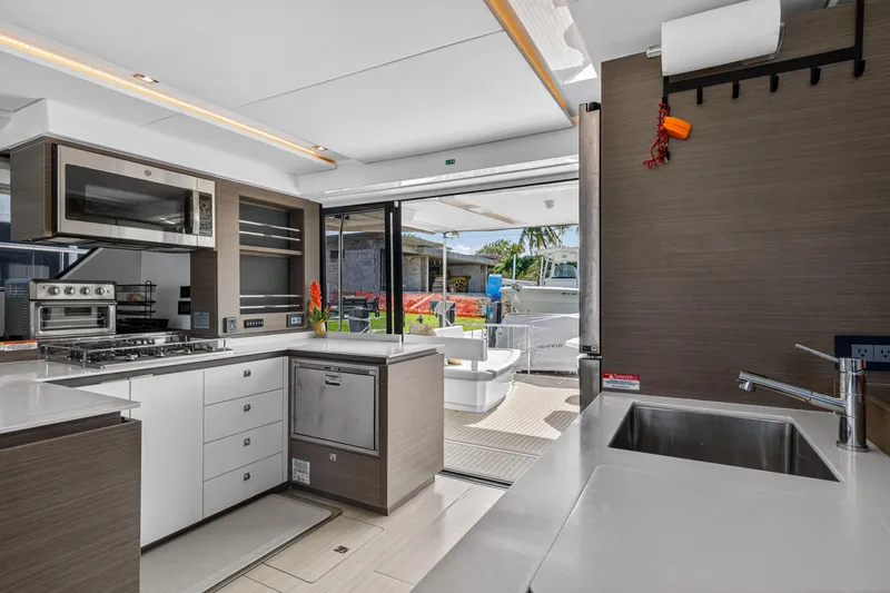 Slide: The Image of Modern kitchen interior of 2022 Leopard 53 Powercat yacht with sleek appliances and outdoor view. - 64