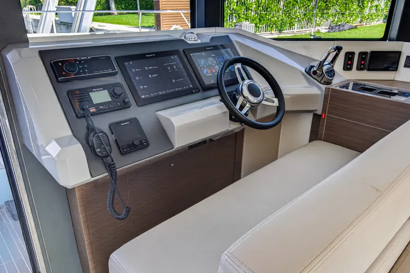 Slide: The Image of Helm station of 2022 Leopard 53 Powercat with modern navigation controls and steering wheel. - 74