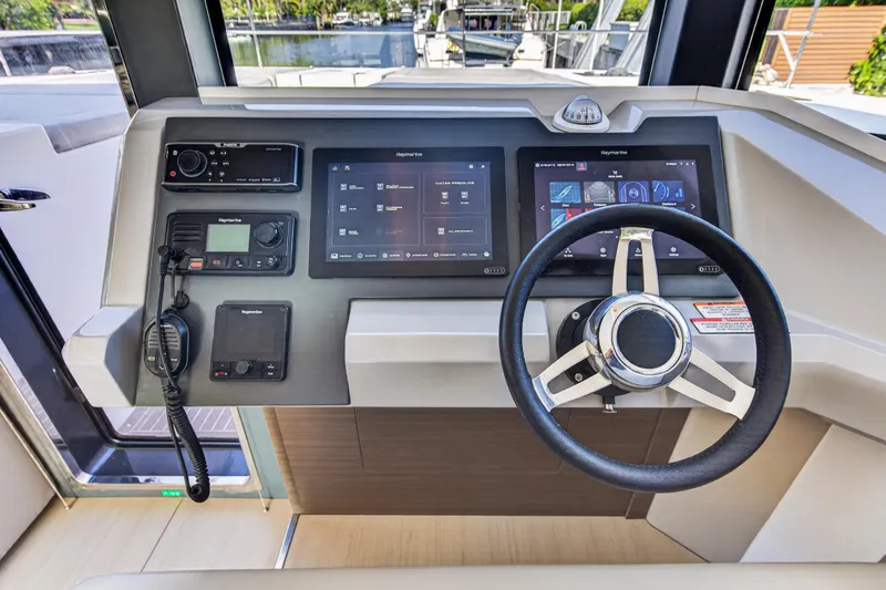 Slide: The Image of Control panel of 2022 Leopard 53 Powercat with steering wheel and navigation screens. - 76