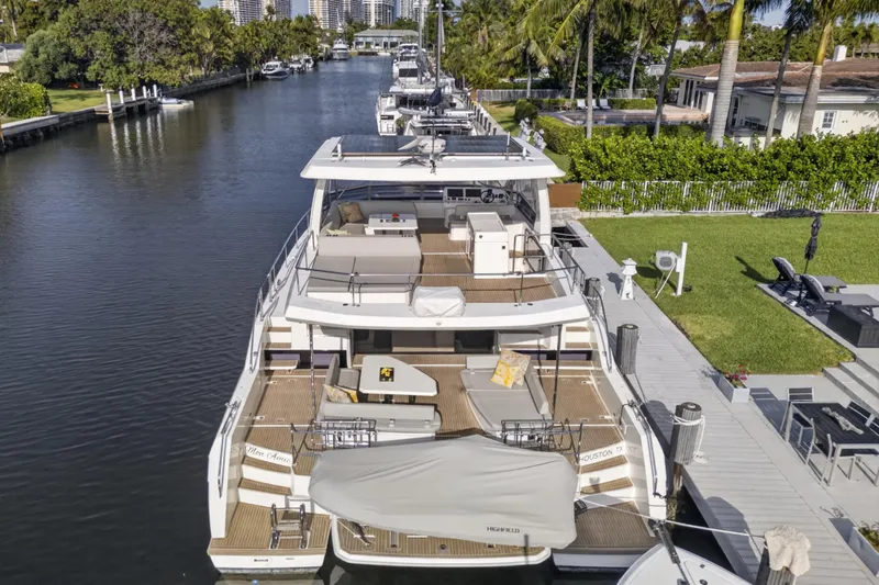 Slide: The Image of 2022 Leopard 53 Powercat yacht docked in a scenic canal setting. - 8