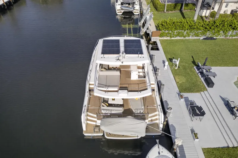 Slide: The Image of Aerial view of 2022 Leopard 53 Powercat yacht docked, featuring solar panels and spacious deck. - 9