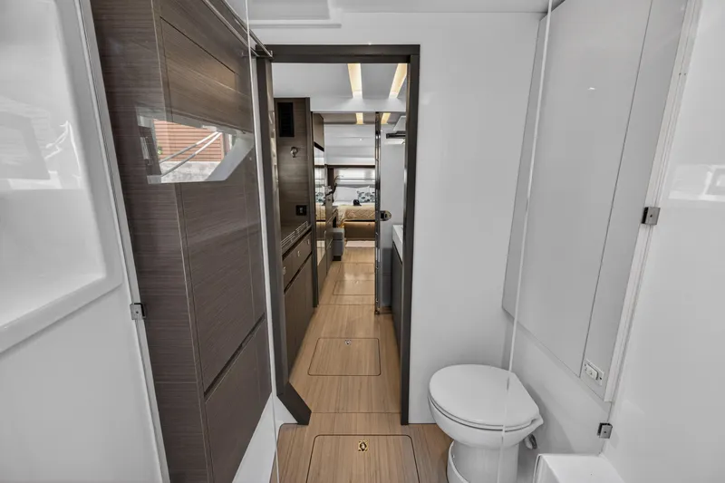 Slide: The Image of Interior view of 2022 Leopard 53 Powercat yacht, featuring modern bathroom and hallway design. - 97