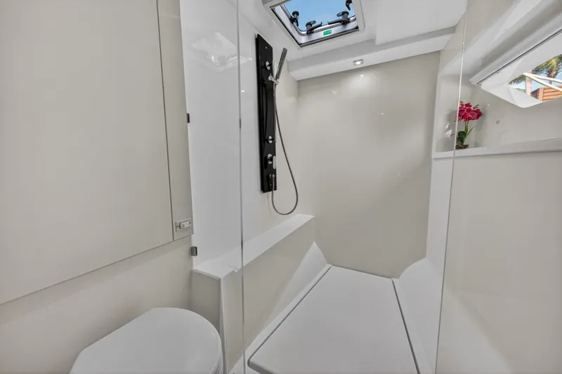 Slide: The Image of Modern bathroom interior on 2022 Leopard 53 Powercat yacht, featuring sleek design and skylight. - 98