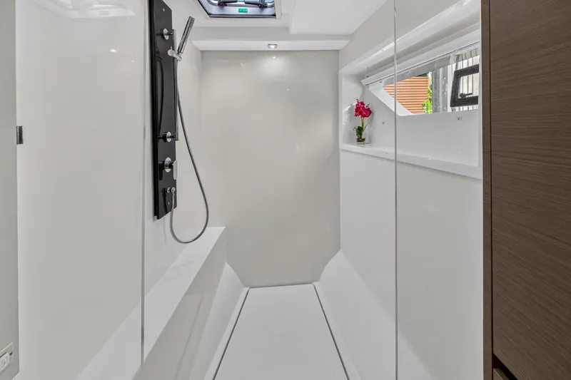 Slide: The Image of Modern shower area in 2022 Leopard 53 Powercat yacht, featuring sleek design and window view. - 99