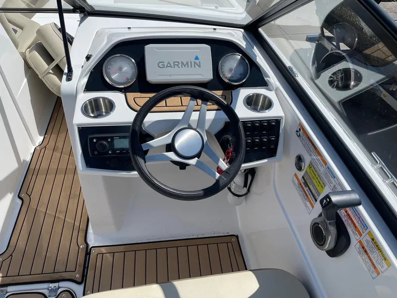 Slide: The Image of Cockpit of 2020 Hurricane SD235 boat with Garmin navigation system and wooden flooring. - 15