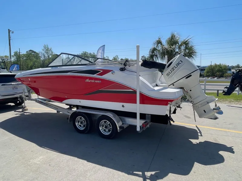 Slide: The Image of 2020 Hurricane SD235 boat with Suzuki outboard motor on trailer, parked outdoors. - 3