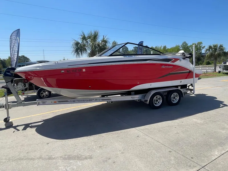 Slide: The Image of 2020 Hurricane SD235 boat on trailer, red and white design, parked outdoors. - 5