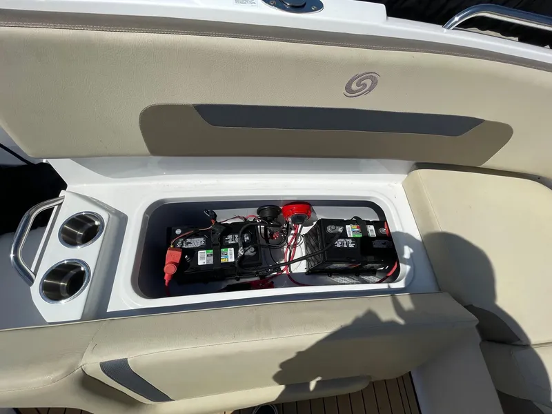 Slide: The Image of 2020 Hurricane SD235 boat battery compartment with cup holders and seating. - 8