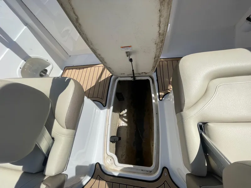 Slide: The Image of Open storage compartment on 2020 Hurricane SD235 boat, surrounded by beige seating. - 9