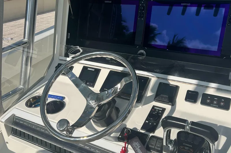 Slide: The Image of 2020 SeaVee 340Z boat dashboard with steering wheel and Simrad navigation displays. - 10