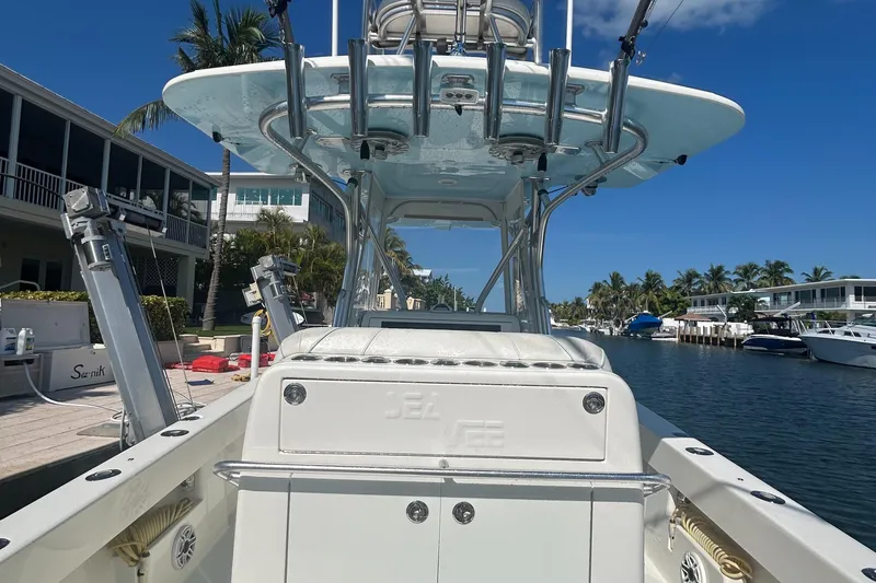 Slide: The Image of 2020 SeaVee 340Z boat docked in a sunny canal with palm trees and houses. - 11