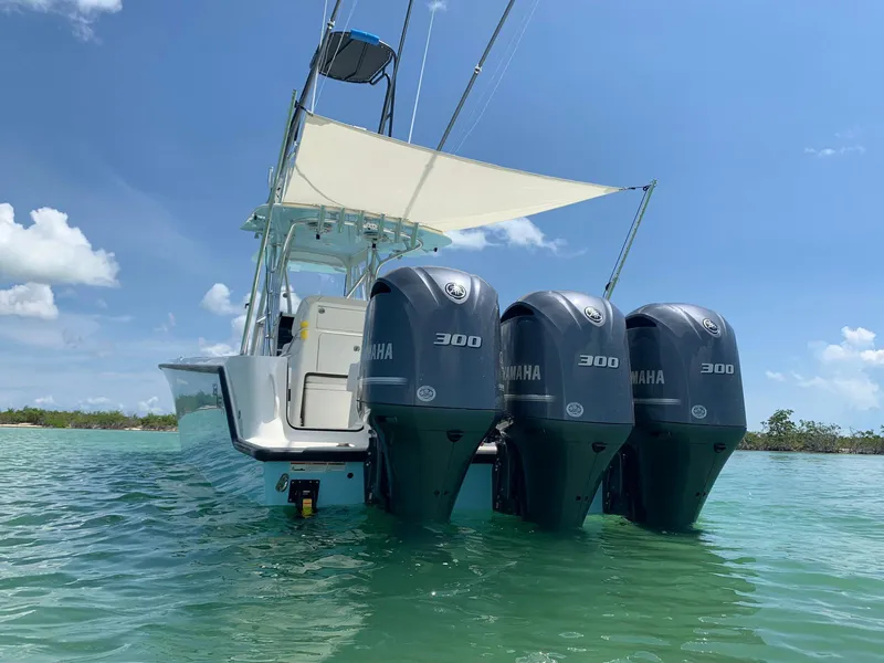 Slide: The Image of 2020 SeaVee 340Z boat with triple Yamaha 300 engines on clear water. - 12