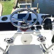 Slide: The Image of 2020 SeaVee 340Z boat dashboard with steering wheel and electronic controls. - 16