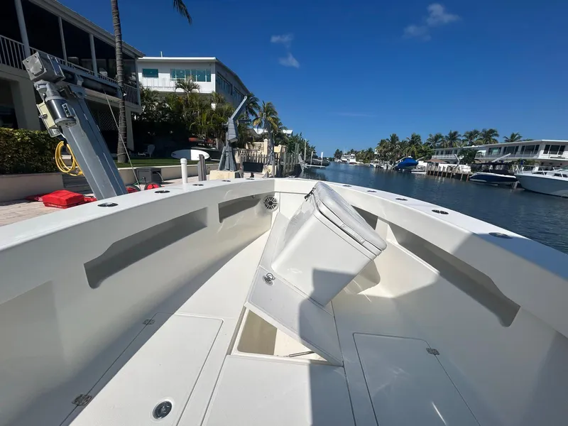 Slide: The Image of 2020 SeaVee 340Z boat docked in a sunny canal, surrounded by waterfront homes. - 2