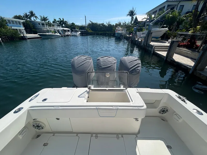 Slide: The Image of 2020 SeaVee 340Z boat with triple engines docked in a serene waterfront setting. - 5