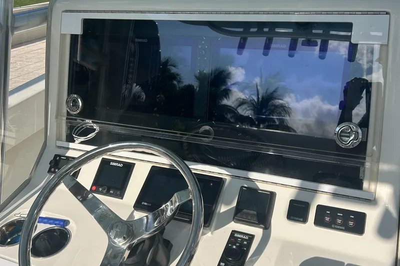 Slide: The Image of 2020 SeaVee 340Z boat dashboard with Simrad electronics and steering wheel. - 6