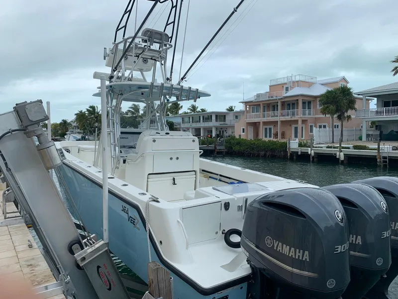 Slide: The Image of 2020 SeaVee 340Z boat docked with Yamaha engines, coastal homes in background. - 8