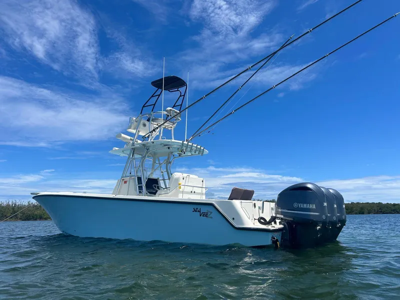 Slide: The Image of 2020 SeaVee 340Z boat with Yamaha engines on clear water under blue sky. - 9