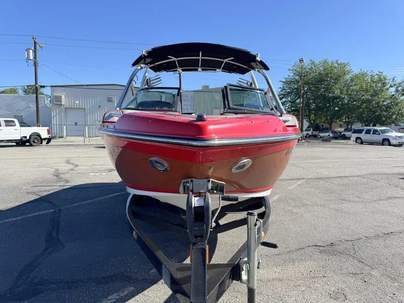 Slide: The Image of 2009 Supra 21V LAUNCH boat on trailer in parking lot, sunny day. - 7