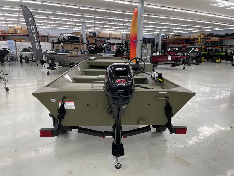 Slide: The Image of 2025 Lowe Jon L1852MT boat with Mercury engine displayed in showroom. - 2