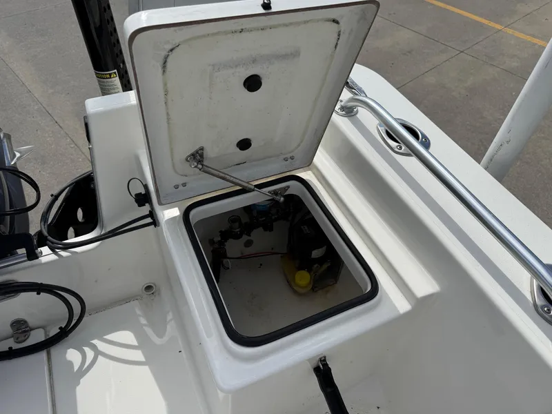 Slide: The Image of Open storage compartment on a 2020 Bay Rider 239 Bay boat, showing internal components. - 11
