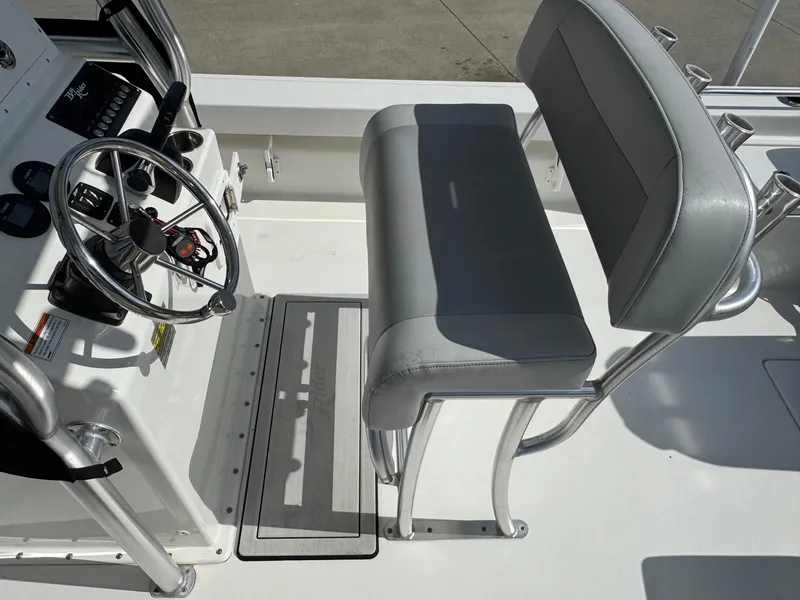 Slide: The Image of 2020 Bay Rider 239 Bay boat helm with steering wheel and cushioned seat. - 12