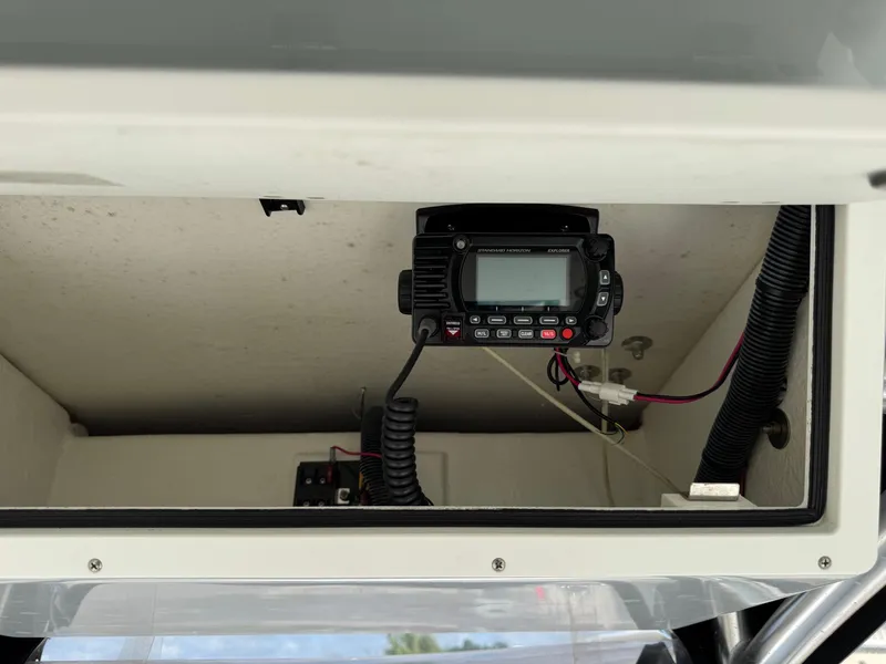 Slide: The Image of 2020 Bay Rider 239 Bay boat radio compartment with electronic equipment. - 19