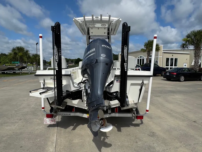 Slide: The Image of 2020 Bay Rider 239 Bay boat with Yamaha engine, parked outdoors under cloudy sky. - 2