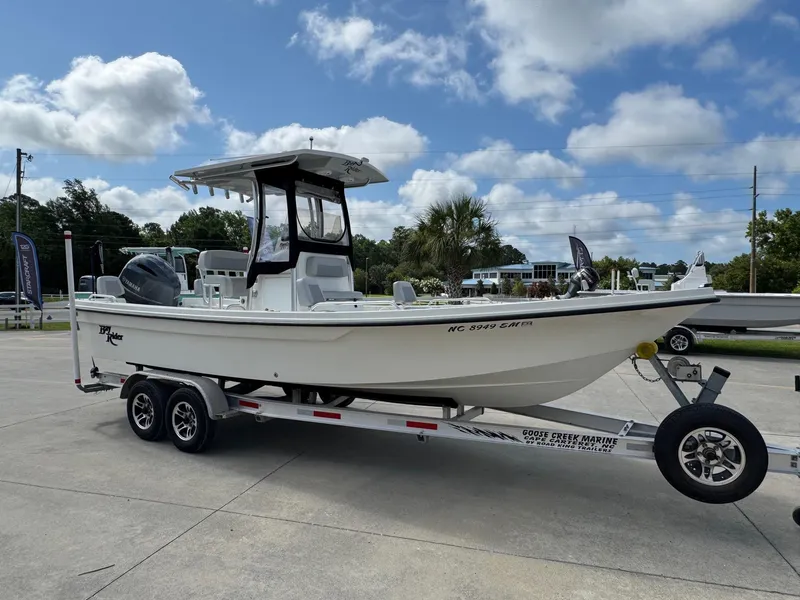 Slide: The Image of 2020 Bay Rider 239 Bay boat on trailer under blue sky. - 5