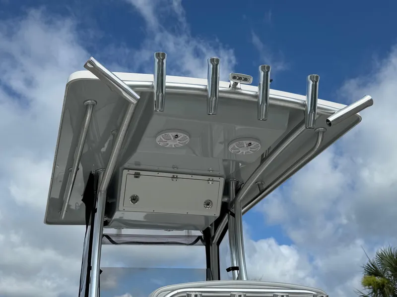 Slide: The Image of T-top of 2020 Bay Rider 239 Bay boat with rod holders against a cloudy sky. - 7