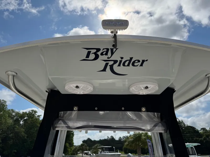 Slide: The Image of Bay Rider 239 Bay 2020 boat with speakers, under a partly cloudy sky. - 8