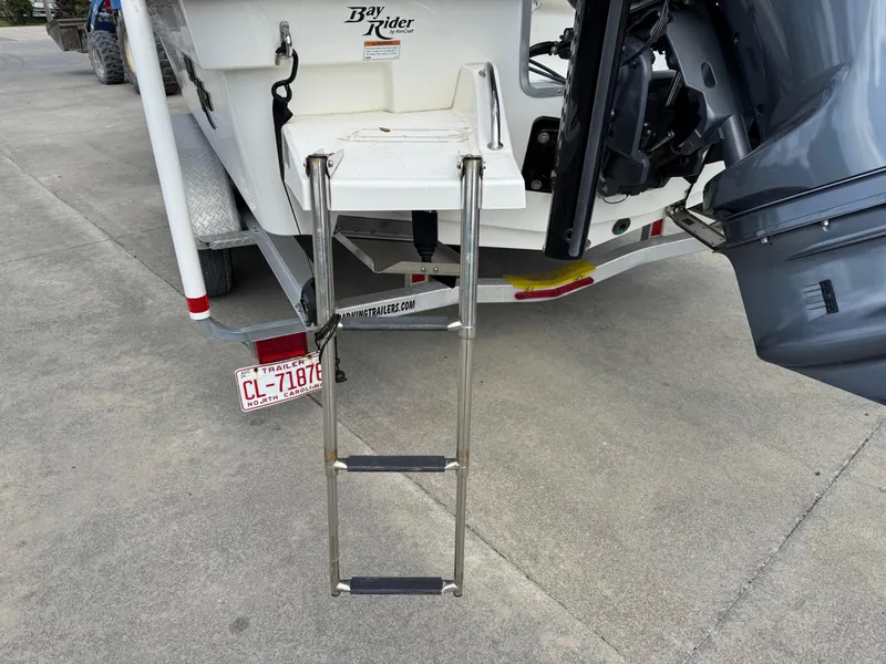 Slide: The Image of 2020 Bay Rider 239 Bay boat with ladder and outboard motor on trailer. - 9