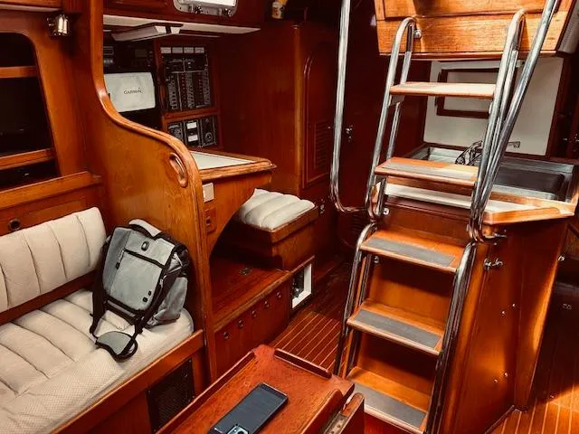 Slide: The Image of Interior of 1983 Stevens 40 sailboat with wooden furnishings and seating area. - 10