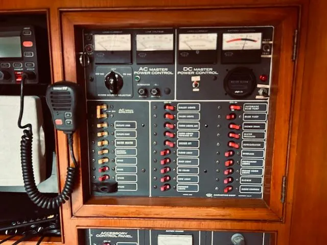 Slide: The Image of Control panel of a 1983 Stevens 40 boat with AC/DC power controls and radio handset. - 13