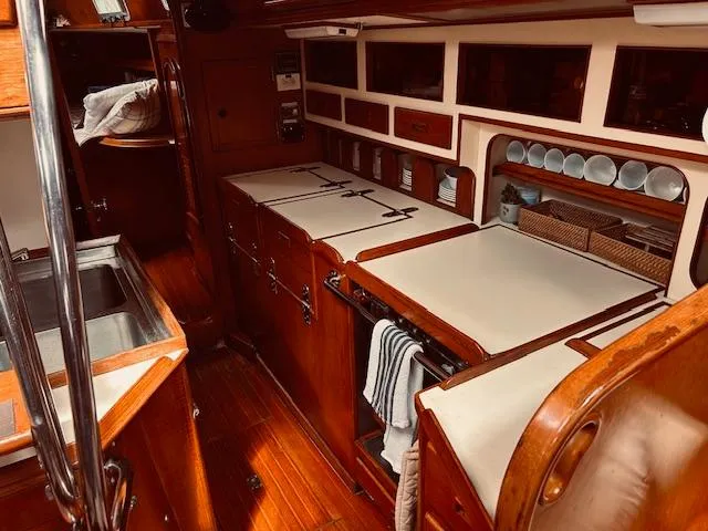 Slide: The Image of 1983 Stevens 40 yacht interior with wooden cabinetry and kitchen amenities. - 14