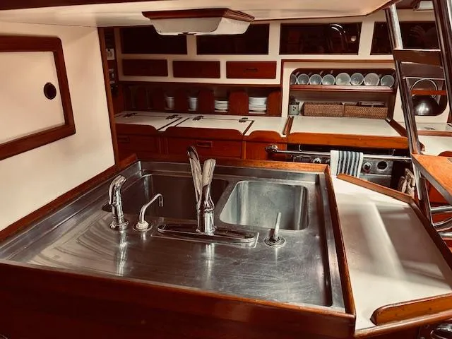 Slide: The Image of Luxurious 1983 Stevens 40 yacht kitchen with stainless steel sink and wooden cabinetry. - 18