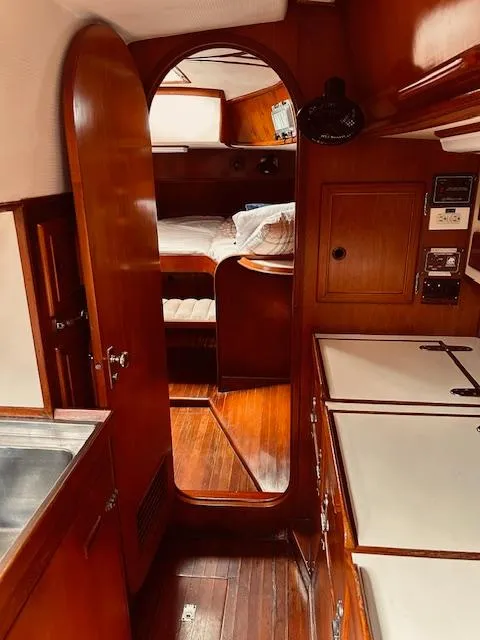 Slide: The Image of Interior of a 1983 Stevens 40 yacht with wooden cabinetry and cozy sleeping area. - 19