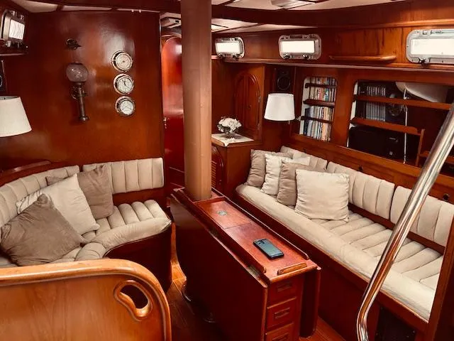 Slide: The Image of Luxurious 1983 Stevens 40 yacht interior with plush seating, wooden finishes, and nautical decor. - 2