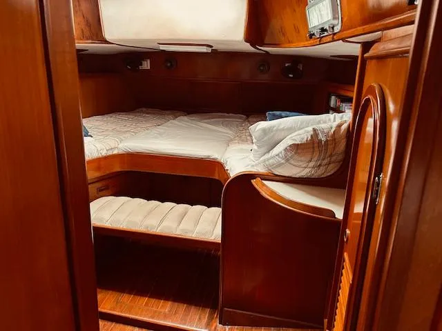 Slide: The Image of Cozy cabin interior of a 1983 Stevens 40 yacht with wooden furnishings and a comfortable bed. - 20