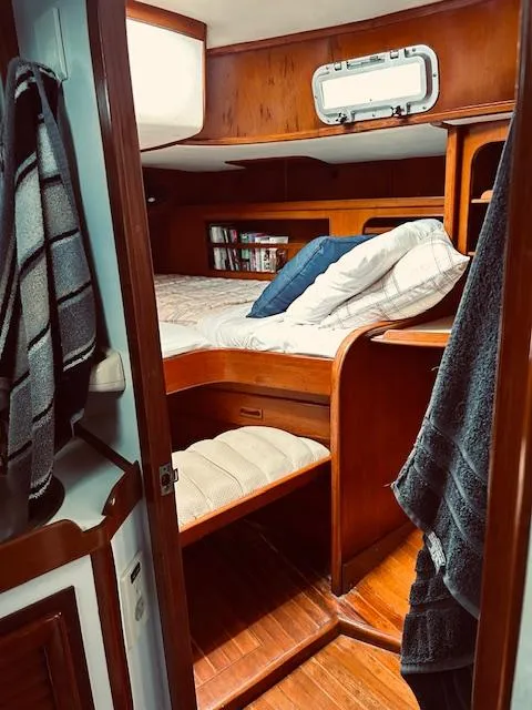 Slide: The Image of Cozy cabin interior of 1983 Stevens 40 sailboat with wooden furnishings and bedding. - 21