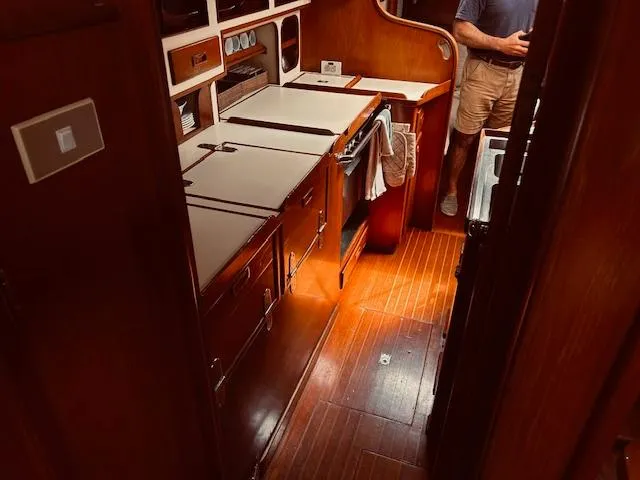 Slide: The Image of 1983 Stevens 40 yacht interior with wooden cabinetry and flooring. - 26