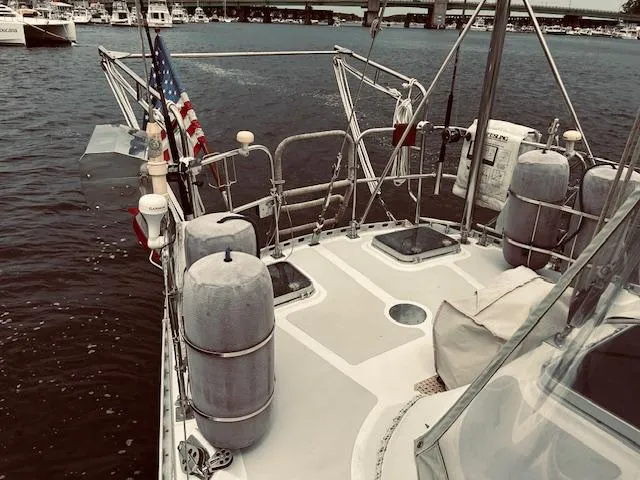 Slide: The Image of Sailboat deck view with American flag, Stevens 40, 1983 model, docked in marina. - 32