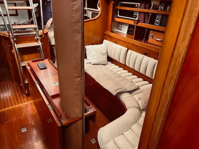 Slide: The Image of Interior of 1983 Stevens 40 yacht with wooden furnishings and cushioned seating. - 4