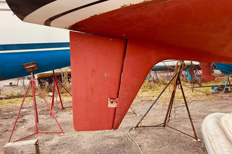 Slide: The Image of Red keel of a 1983 Stevens 40 sailboat on stands in a boatyard. - 42