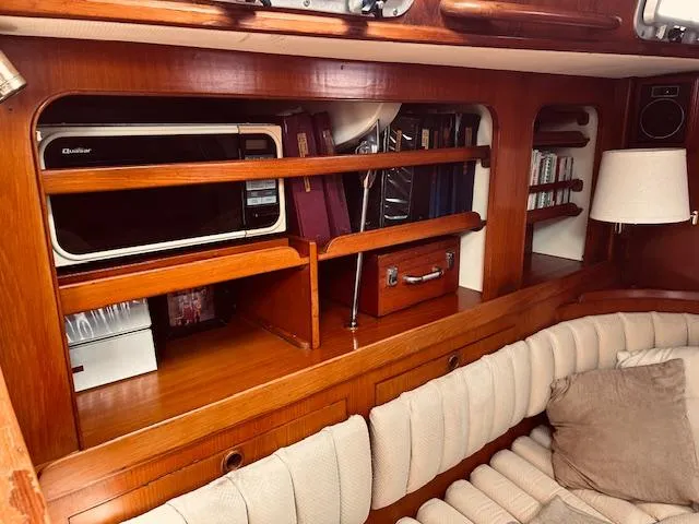Slide: The Image of Interior of 1983 Stevens 40 yacht with wooden shelves and cozy seating area. - 6
