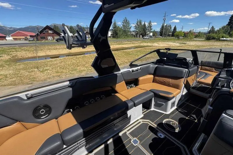 Slide: The Image of 2025 Supra SE boat interior with luxurious seating and modern design under a clear blue sky. - 12